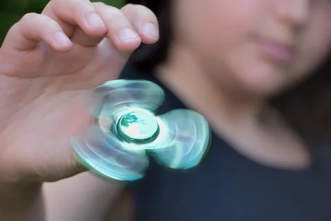 Playing with fidget spinner Stock Photos