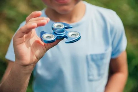 Playing with a Fidget Spinner Stockfoto's