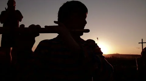 Playing on flute on sunset Stock Footage 65746074