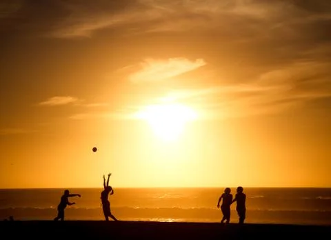 Playing Football Beach Sunset Stock Photos
