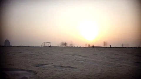 PLAYING FOOTBALL WHILE SUNSET - MOTION LAPSE Video stock 111890584