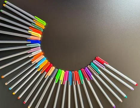 Playing at forming a half moon with colored pens. Stock Photos
