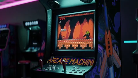 Playing the fun game with pixel graphics on the classic arcade machine Stock Footage 248848258