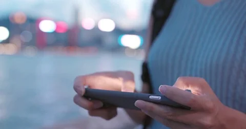 Playing game on cellphone in the evening Stock Footage