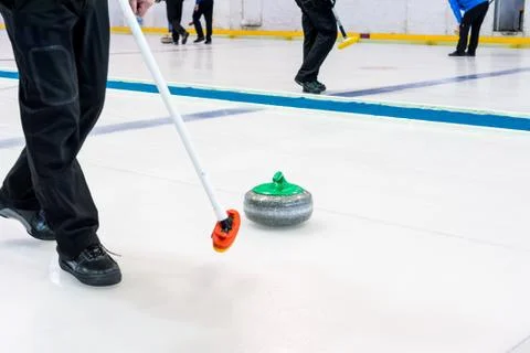 Playing a game of curling. Stock Photos