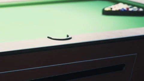 Playing a game at a pool table in a local bar during the evening Stock Footage 344159379