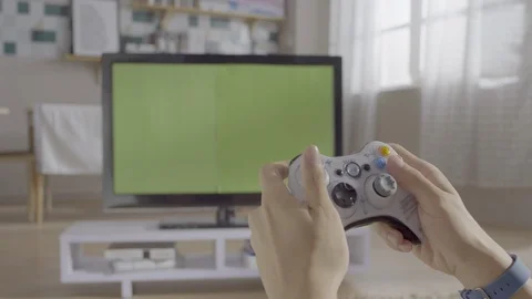 Playing game on TV with green background Stock Footage 111758003