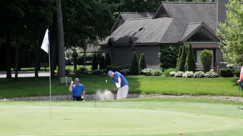 Playing golf, Golfer it's ball from sandpit Stock Footage 124825677