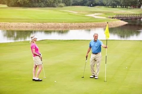Playing golf is something we do together. a mature couple out playing golf Fotos de archivo