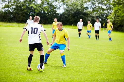 Playing good defense. A group of soccer players in the middle of a game. Stock Photos