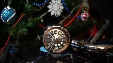 Playing the Gramophone on the Christmas Tree Background. Video stock 84266119