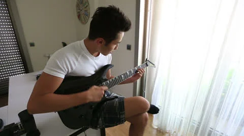 Playing guitar 1 Stock Footage 25420396