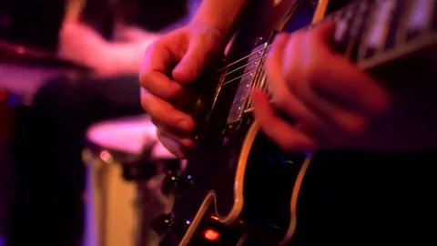 Playing guitar close-up slow motion macro. Guitarist hands pressing chords with Stock Footage 84860672