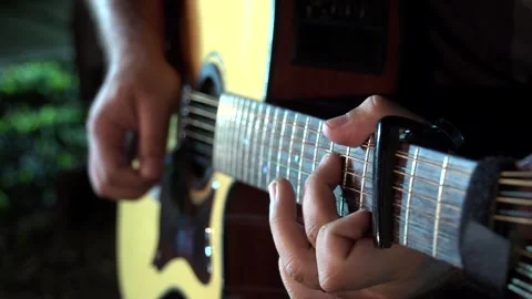 Playing the guitar on a cold night Stock Footage 246157507