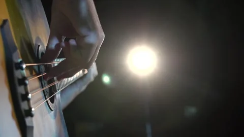 Playing the guitar on a cold night Stock Footage 246157513