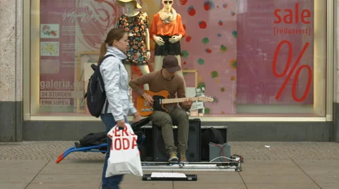 Playing the guitar in front of a store in Berlin Stock Footage 53293658