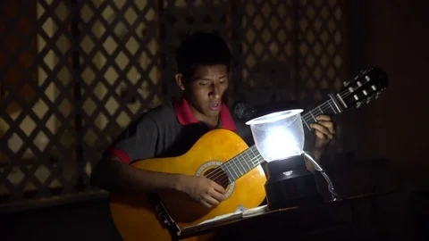 Playing a guitar at night without electricity after Puerto Rico hurricane Stock Footage 82031670