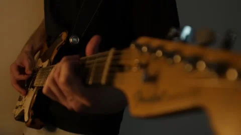 Playing guitar in slow motion Stock Footage 130244883