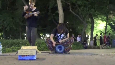 Playing guitar on the street Stock Footage 69184488