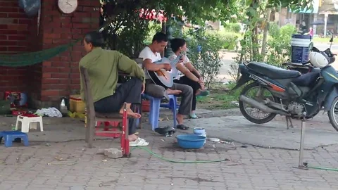 Playing guitar on the street Stock Footage 69186404