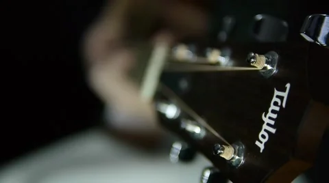 Playing guitar Taylor with black background Stock-Footage 67632967
