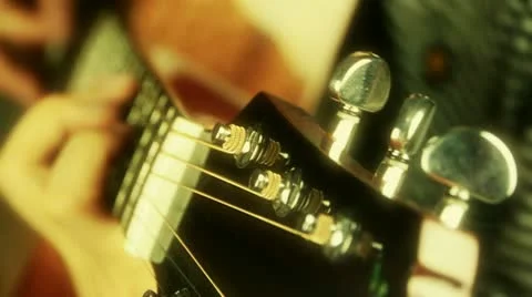 Playing guitar,strum,golden sunlight. Stock Footage