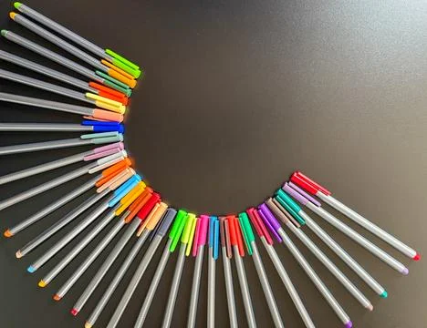 Playing in the half moon formation with colored pens. Stock Photos