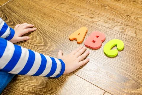 Playing happily with letters Stock Photos