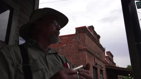 Playing a harmonica on the stoop Stock Footage 51020477