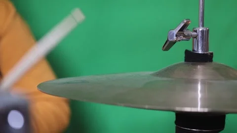 Playing Hi-Hat With A Drumstick On Green Background Close-Up Stock Footage 292978509