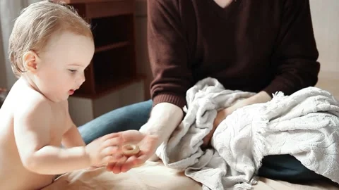 Playing at home on the couch. One-year-old happy child. Funny video. Stock Footage 131714543