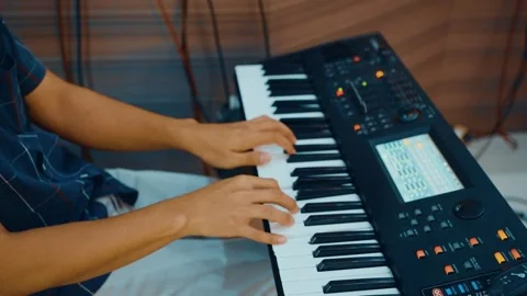 Playing instruments with a piano keyboard. Stock Footage 250380606