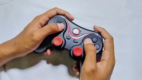 Playing joystick console game Stock Footage 285571098
