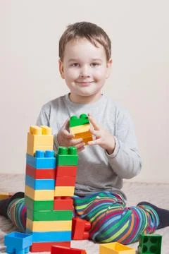 Playing little boy with colored cubes Stock Photos