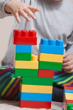 Playing little boy with colored cubes Stock Photos