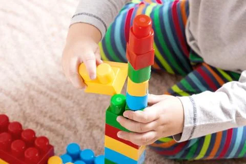 Playing little boy with colored cubes Stock Photos