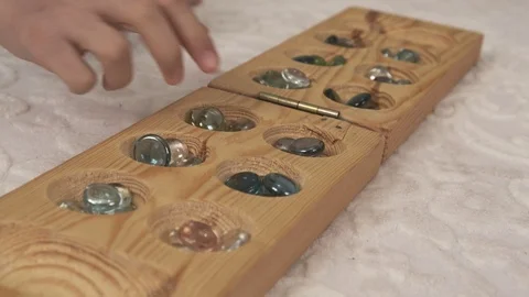 Playing mancala at home, mancala intelligence game on carpet, 스톡 동영상 126407604