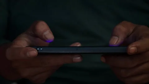Playing a mobile game on a smartphone Video stock 339831080