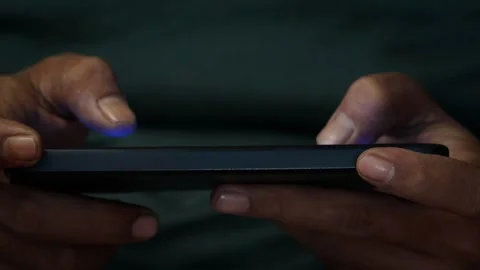 Playing a mobile game on a smartphone Stock Footage 339831097
