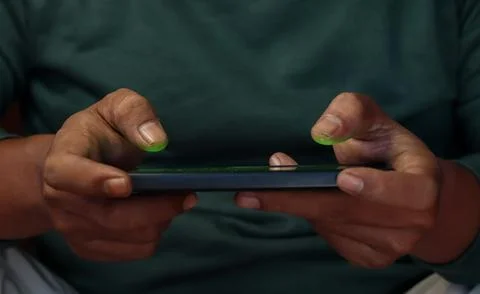 Playing a mobile game on a smartphone Stock Photos
