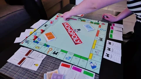 Playing Monopoly Board Game at Home - Strategy and Fun in Family Setting Stock Footage 324685706