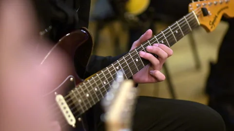 Playing musical instruments. Musicians perform chords on electric guitar Stock Footage 182364590