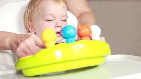 Playing on a musical toy Stock Footage 138650475