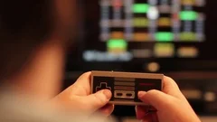 Playing NES with tv in background Stock Footage