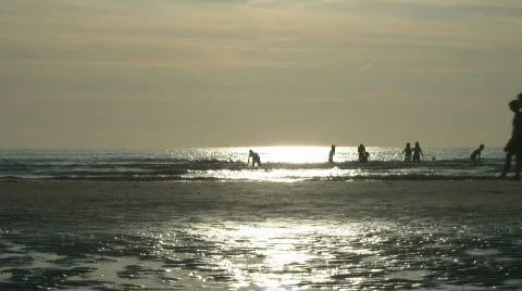 Playing in the ocean walking on the beach the Netherlands 스톡 동영상 642636