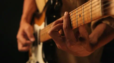 Playing old electrical guitar in black Stock Footage 10678027