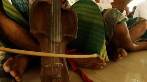 Playing on an old string instrument during the prayer of the Bodo tribe in the t Stock Footage 113287363