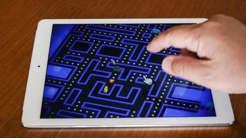 Playing Pacman arcade game on Apple Ipad Stock Footage 114314998