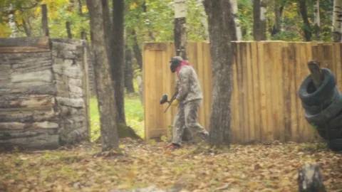 Playing paintball in the Woods Stock Footage 93330672