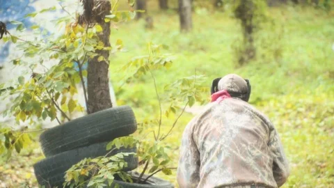 Playing paintball in the Woods Stock Footage 93330893